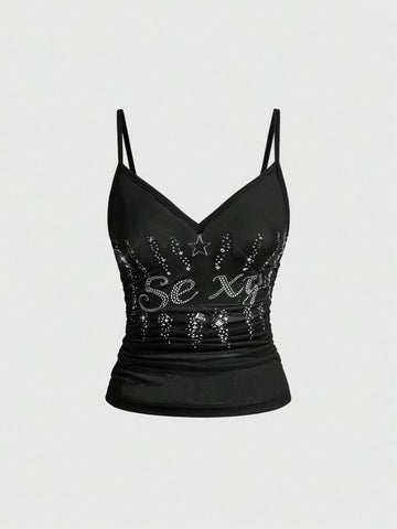 Women's black sheer mesh crop cami top with sparkling rhinestone embellishments, ruched detailing, and thin spaghetti straps.