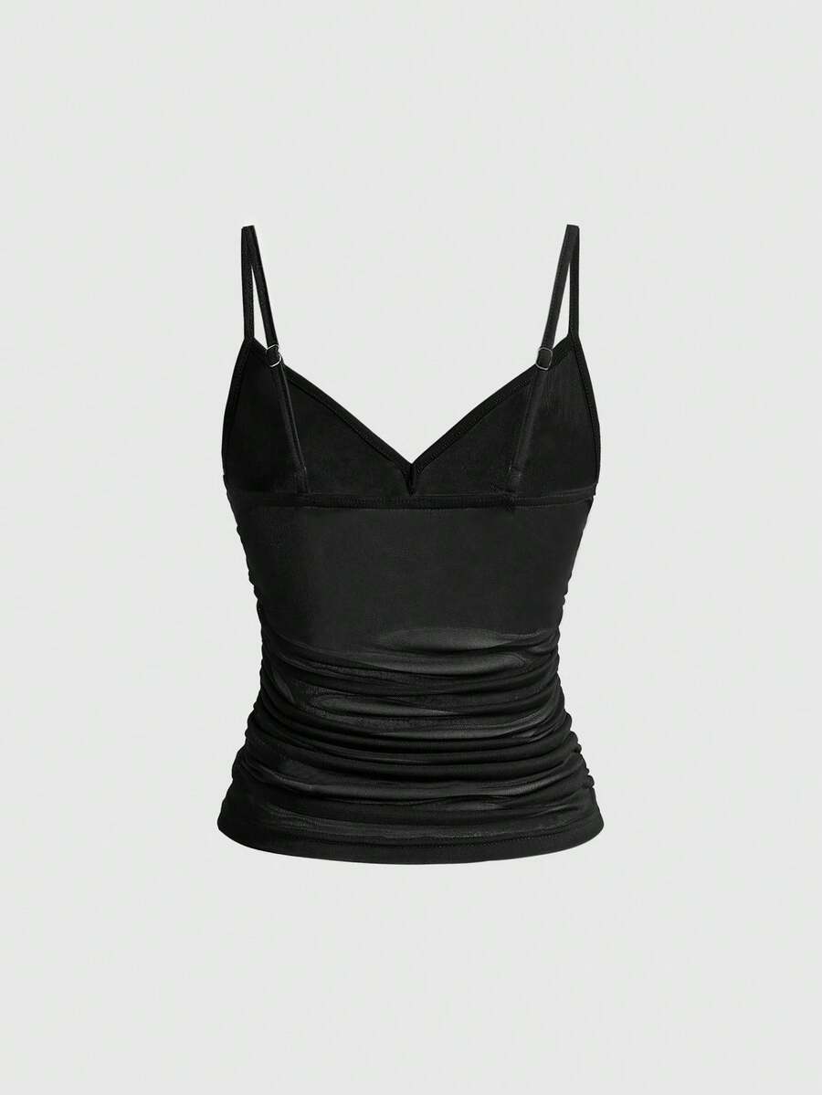 Women's black sheer mesh crop cami top with sparkling rhinestone embellishments, ruched detailing, and thin spaghetti straps.