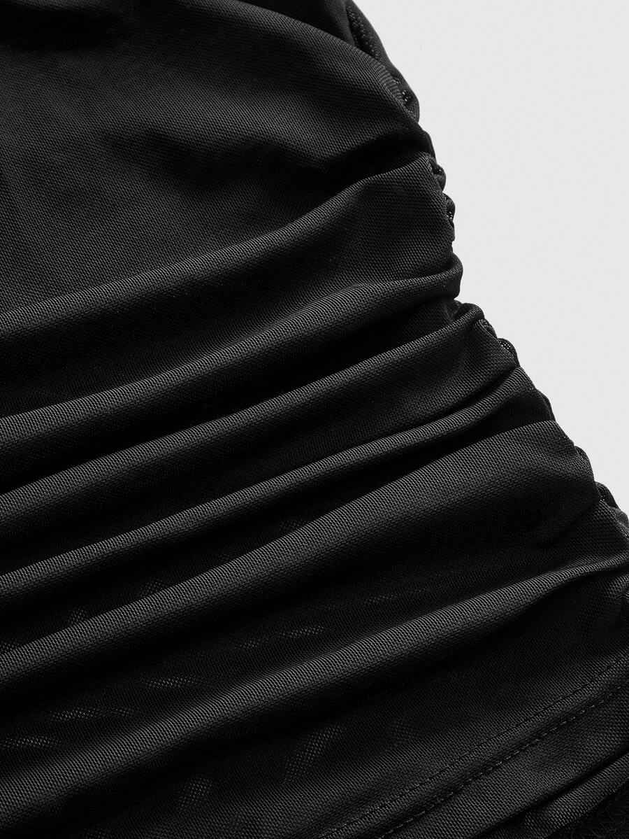 Women's black sheer mesh crop cami top with sparkling rhinestone embellishments, ruched detailing, and thin spaghetti straps.