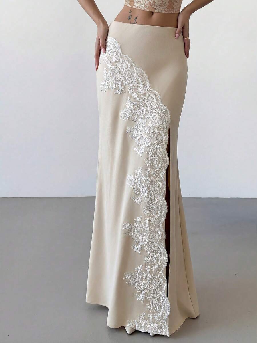 Women's apricot satin fishtail maxi skirt featuring a low waist, slit detail, lined body, and zipper closure.