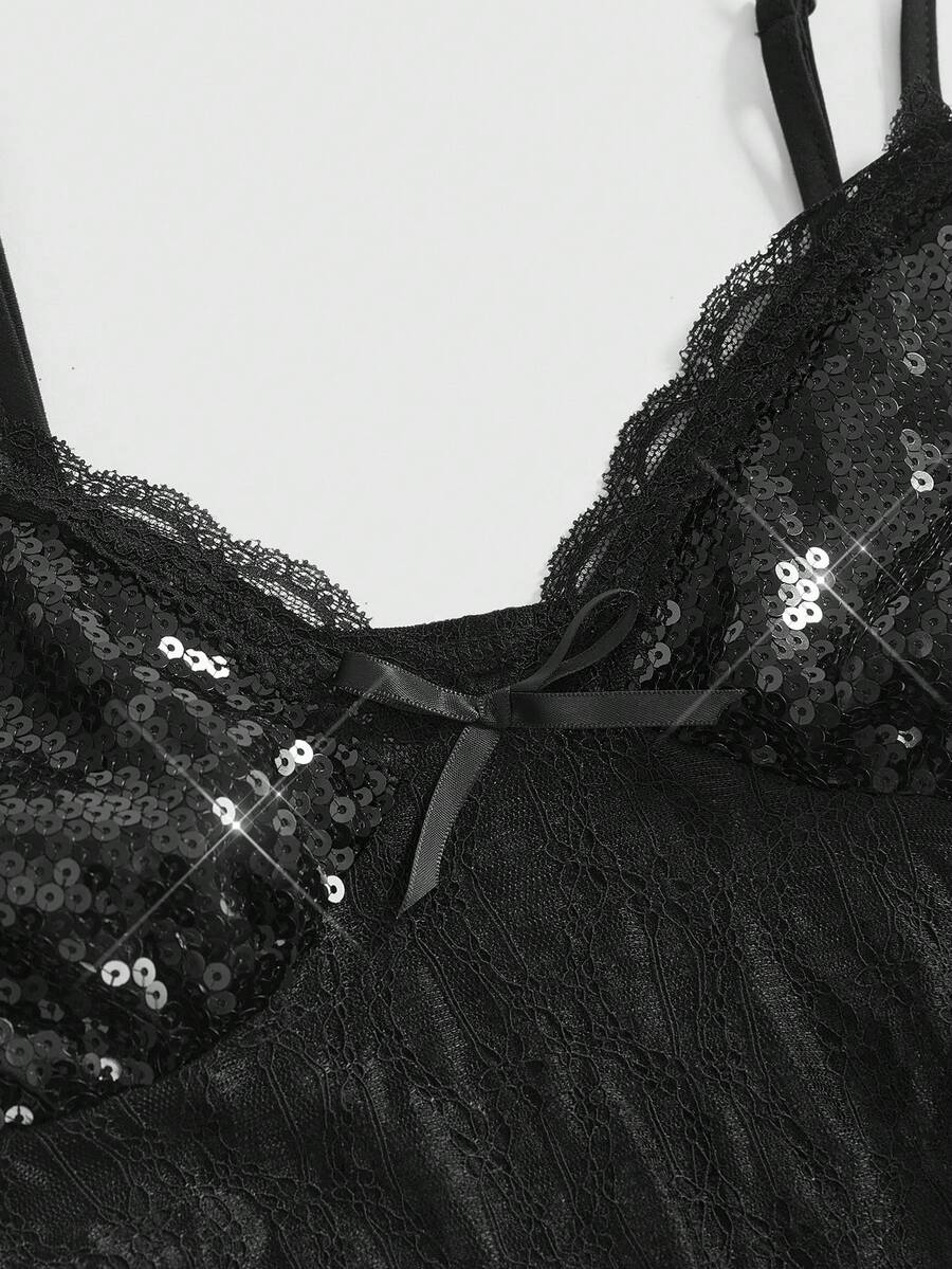 Women's black sequin contrast lace camisole top featuring a V-neck, backless spaghetti straps, and delicate bow knot detail.