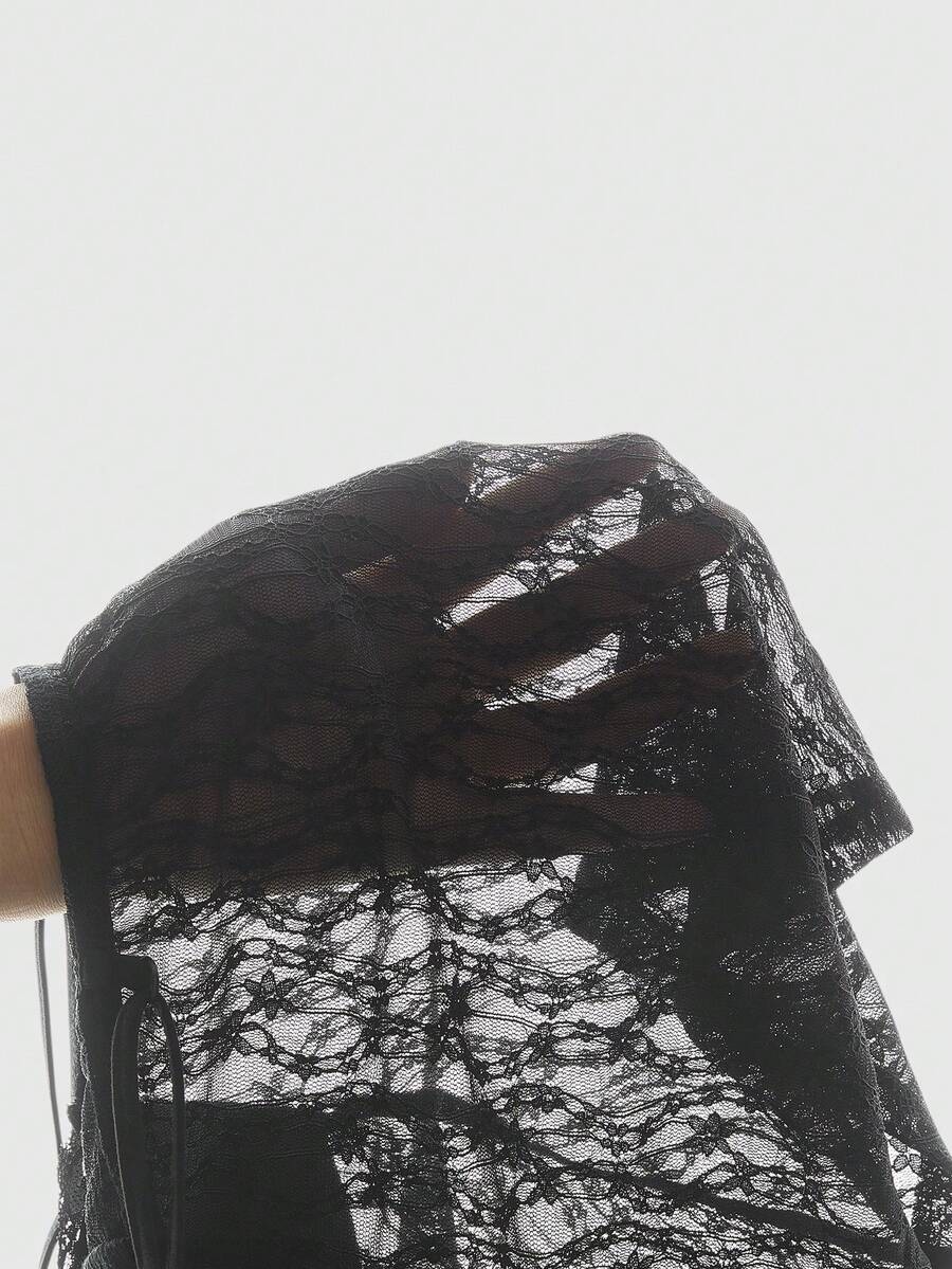 Women's black sequin contrast lace camisole top featuring a V-neck, backless spaghetti straps, and delicate bow knot detail.