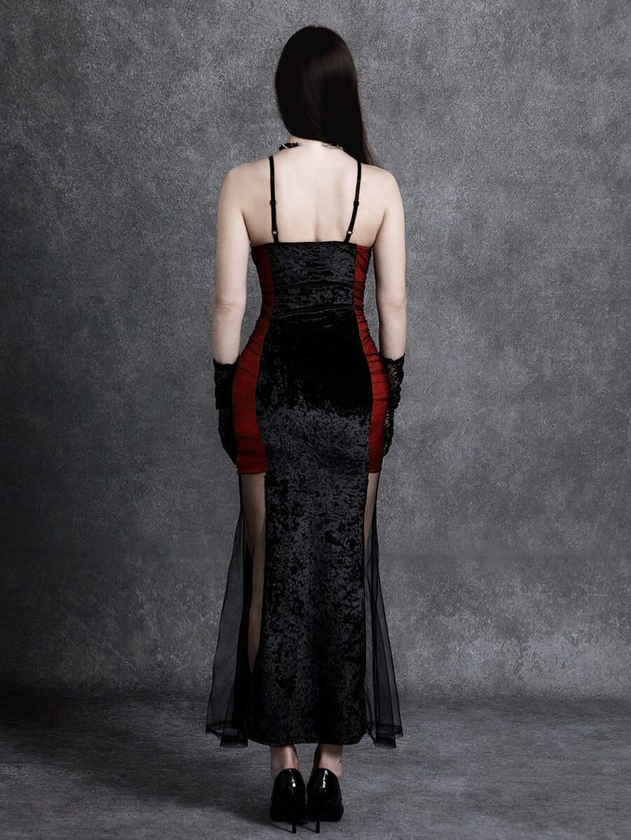 Women wearing an elegant black backless midi cami dress with slender spaghetti straps and a side split thigh hem.