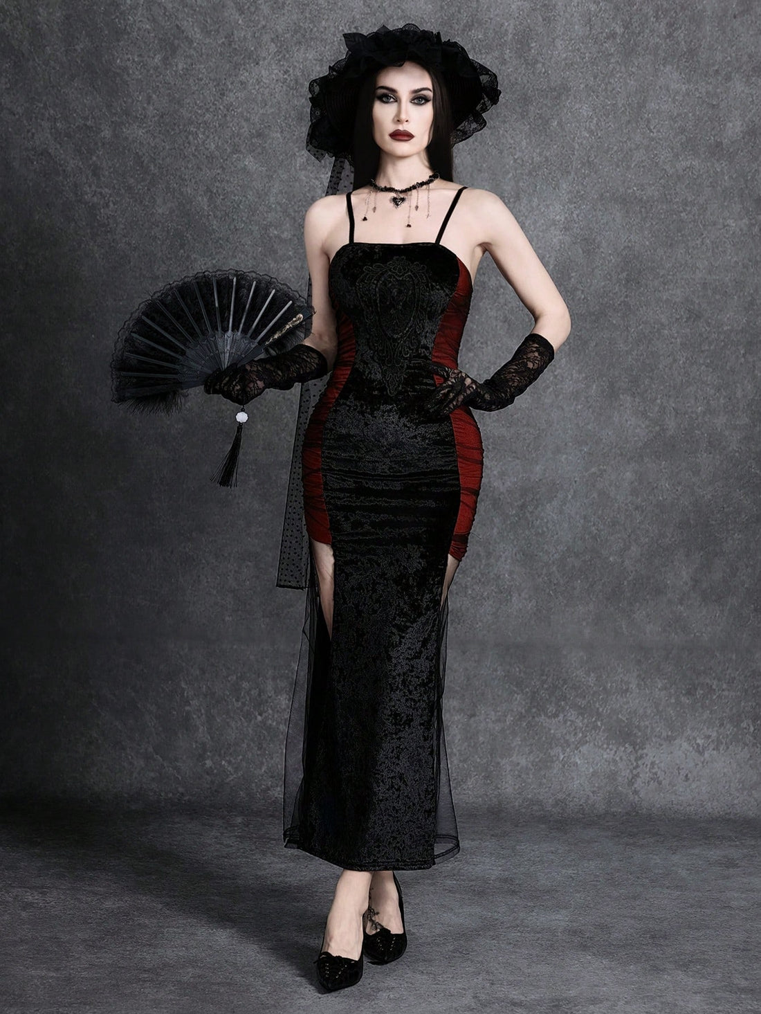 Women wearing an elegant black backless midi cami dress with slender spaghetti straps and a side split thigh hem.