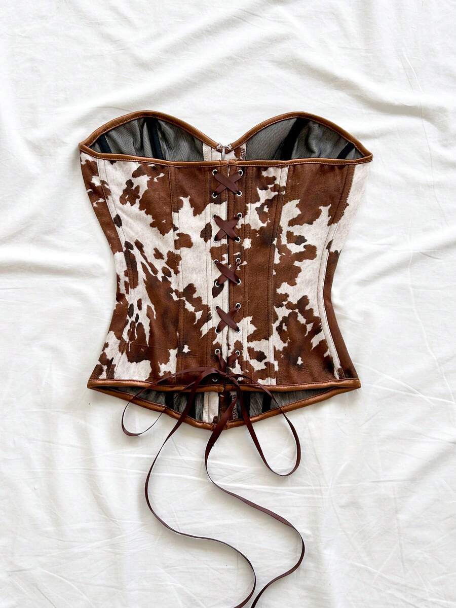 Strapless black lace-up corset top for women with grommet eyelet details, slim fit, lined body, and woven fabric construction.