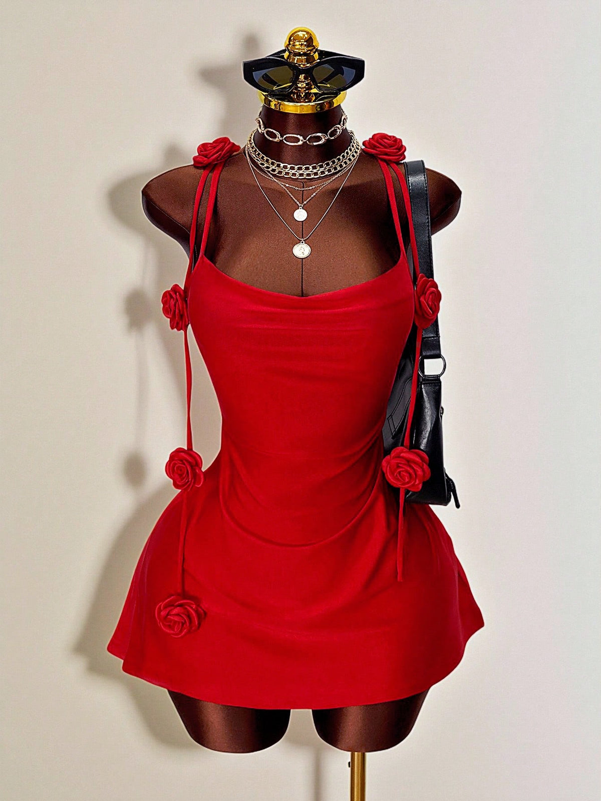 Women's bodycon mini dress featuring a 3D rose accent, thin spaghetti straps, and an open back design.