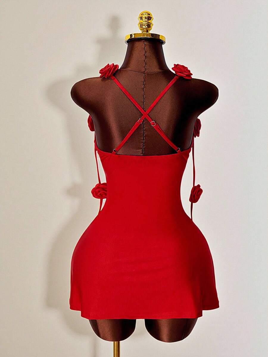 Women's bodycon mini dress featuring a 3D rose accent, thin spaghetti straps, and an open back design.