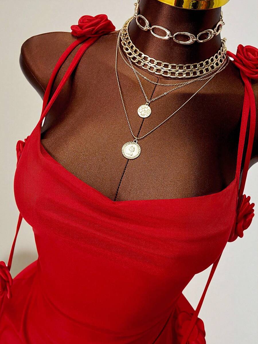 Women's bodycon mini dress featuring a 3D rose accent, thin spaghetti straps, and an open back design.