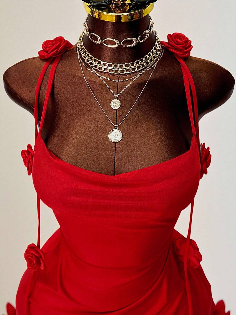 Women's bodycon mini dress featuring a 3D rose accent, thin spaghetti straps, and an open back design.
