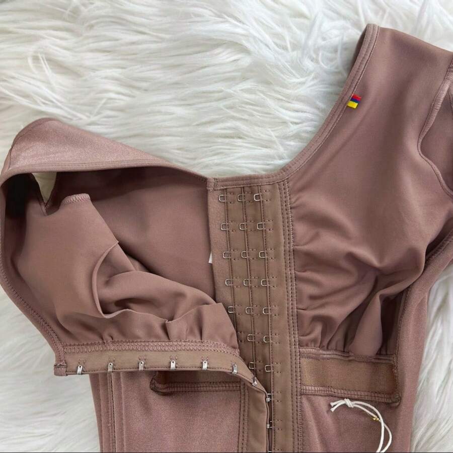 Apricot tummy control shapewear bodysuit for women featuring contrast mesh details, front zipper, and strong support knitwear material.