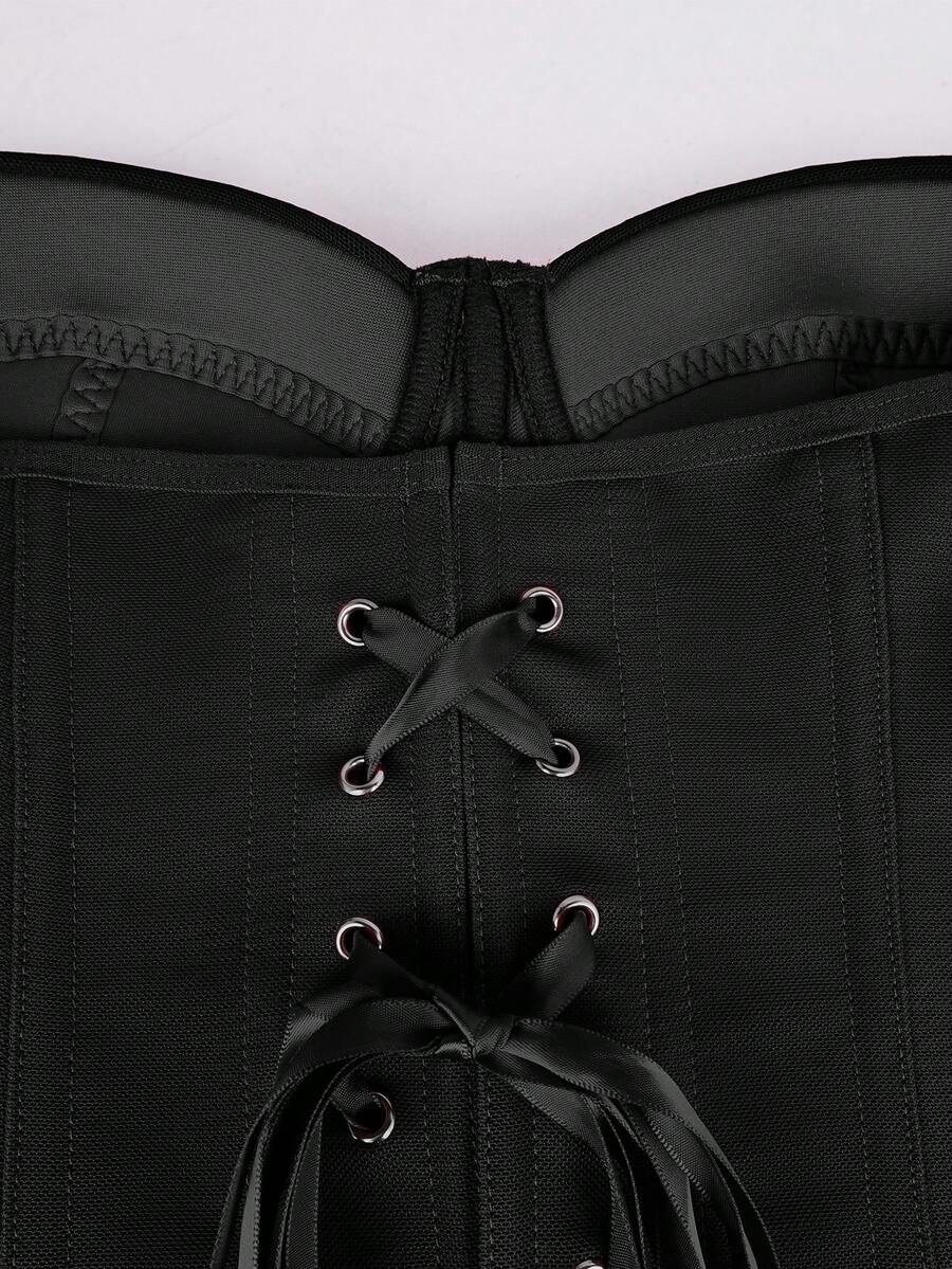 Black strapless corset top with boning, lace-up back, and a cropped slim-fit silhouette for women.