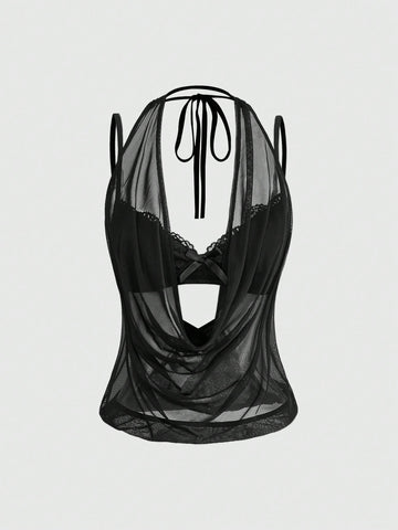 Women wearing a black draped backless halter crop top layered over a boned lace camisole.