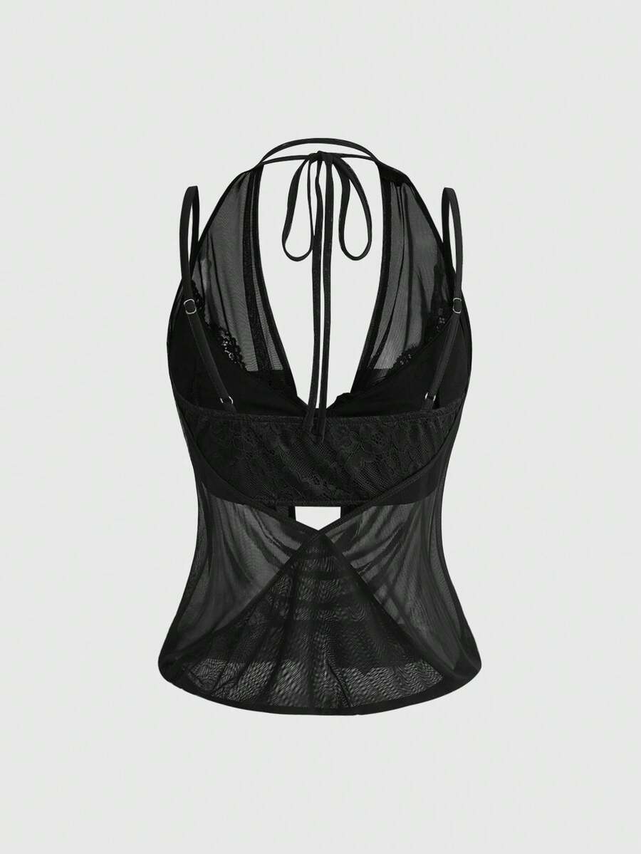 Women wearing a black draped backless halter crop top layered over a boned lace camisole.