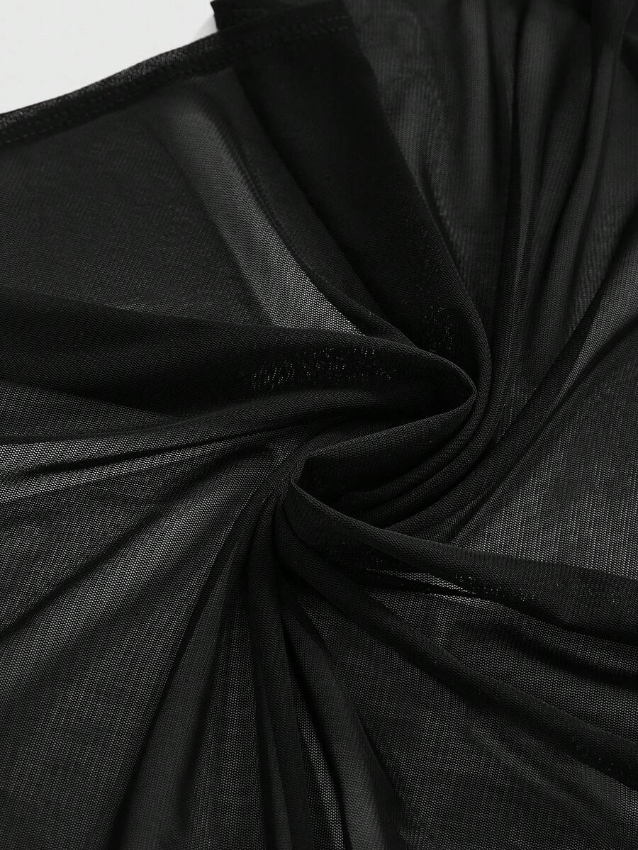 Women wearing a black draped backless halter crop top layered over a boned lace camisole.