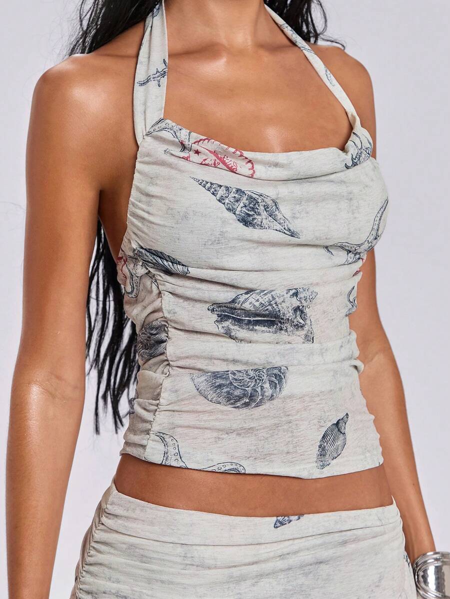 Blue halter cami tank top for women featuring an ocean fish and starfish print, spaghetti straps, slim fit knitted fabric, and a backless lace-up tie design.