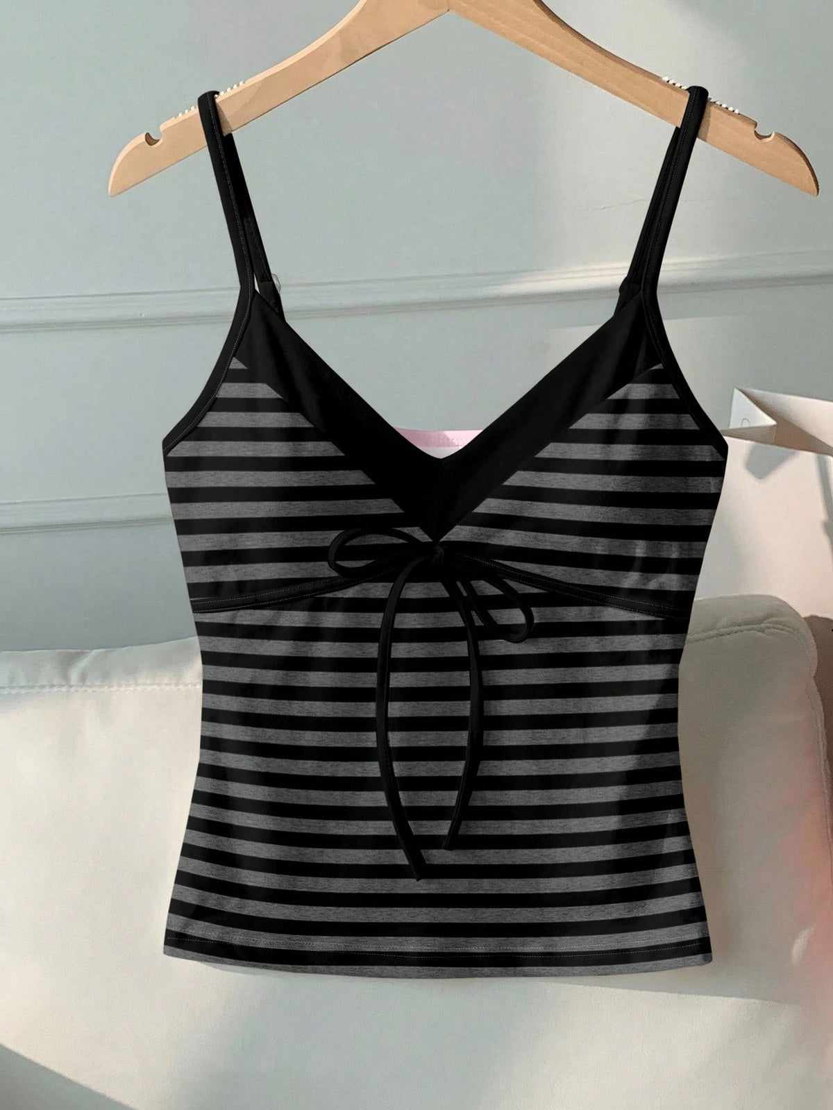 Black and white polka dot tie strap camisole top for women with thin spaghetti straps and slim fit.