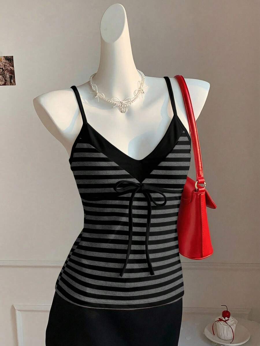 Black and white polka dot tie strap camisole top for women with thin spaghetti straps and slim fit.