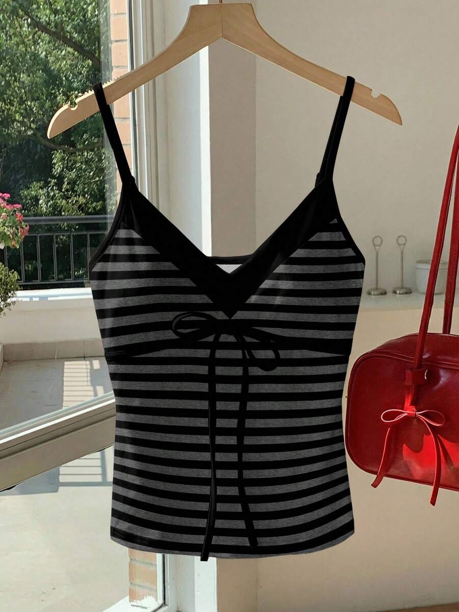 Black and white polka dot tie strap camisole top for women with thin spaghetti straps and slim fit.