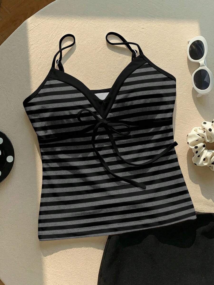 Black and white polka dot tie strap camisole top for women with thin spaghetti straps and slim fit.
