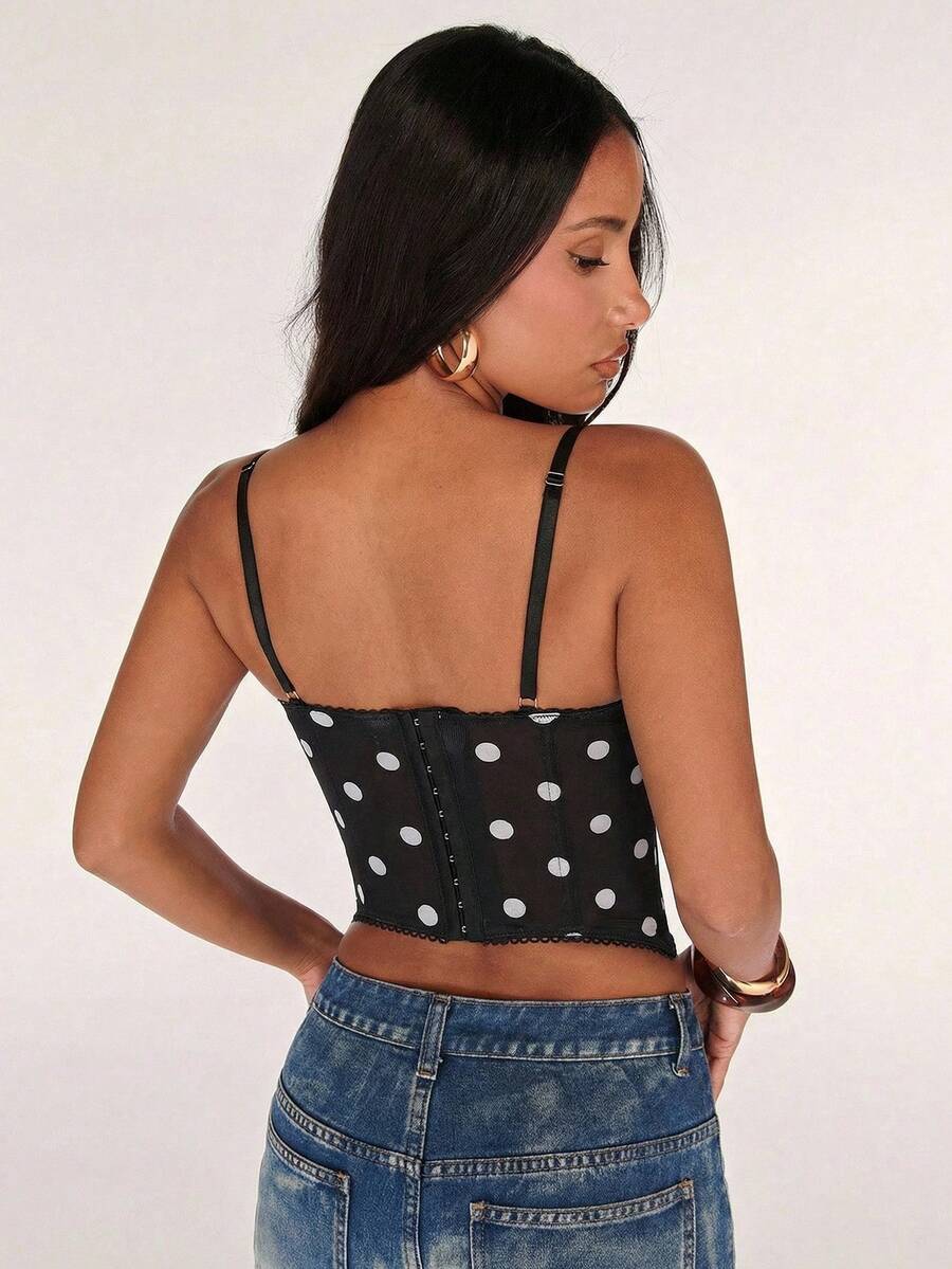 Black women’s lace cami top with spaghetti straps, contrast lace details, and an asymmetrical hem, styled as a slim-fit lined casual top.