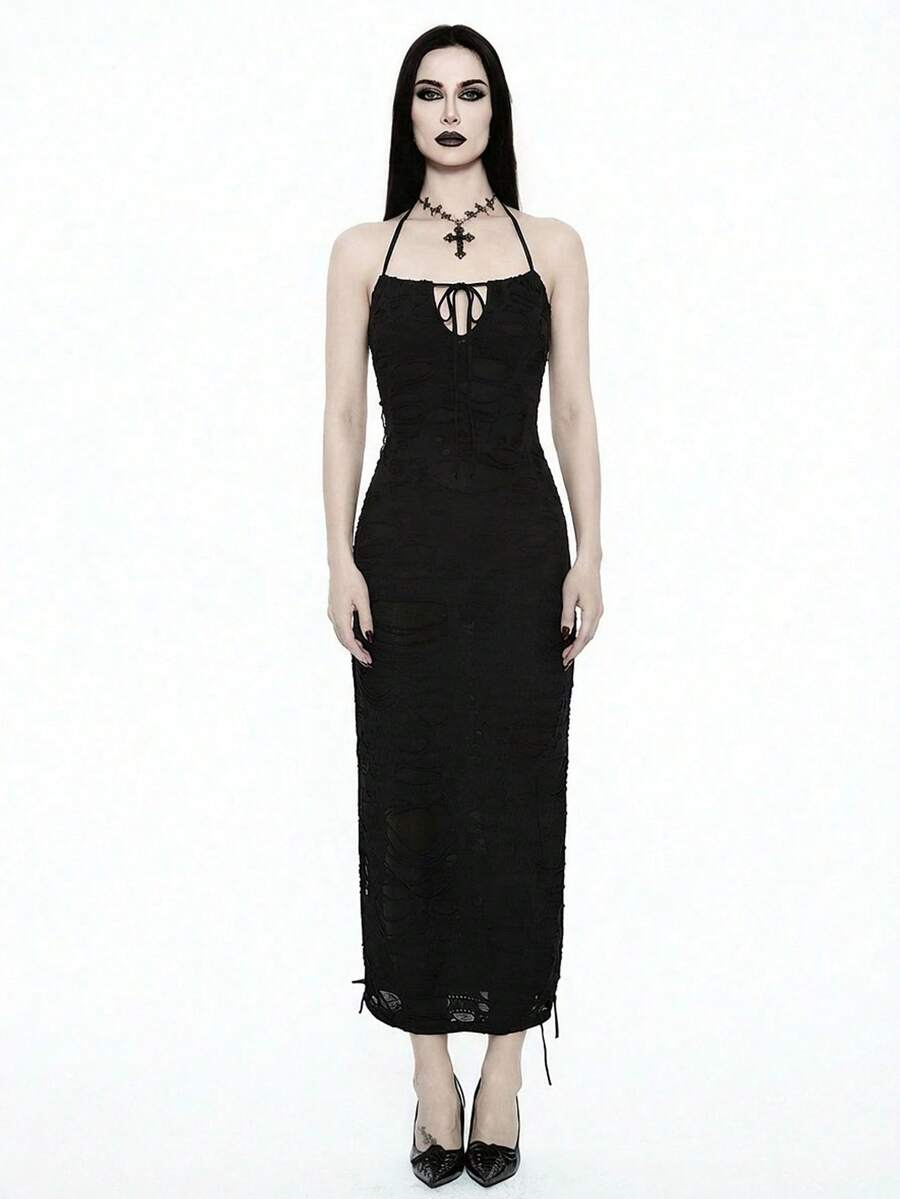 Woman wearing an elegant black sleeveless long cami dress featuring a slim fit silhouette and a backless tie-back design.