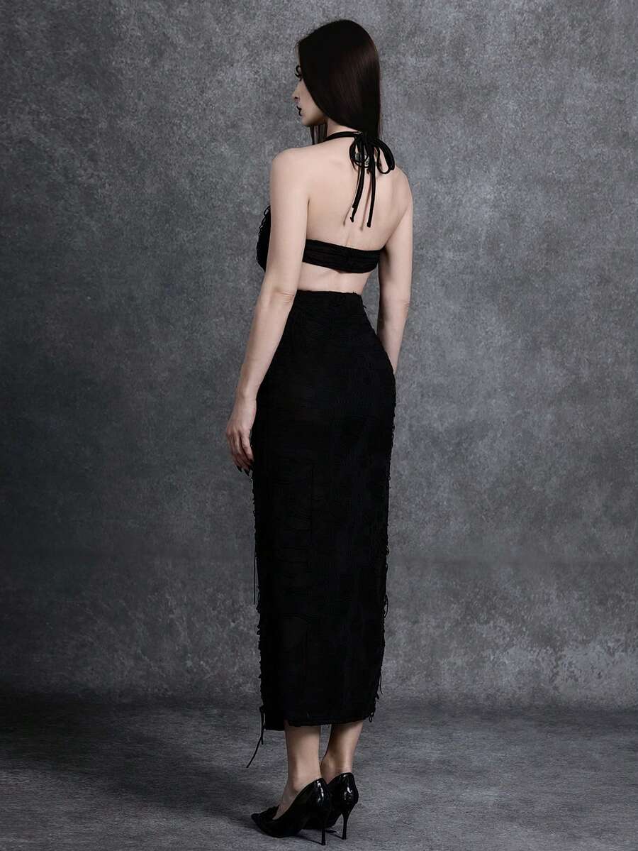 Woman wearing an elegant black sleeveless long cami dress featuring a slim fit silhouette and a backless tie-back design.