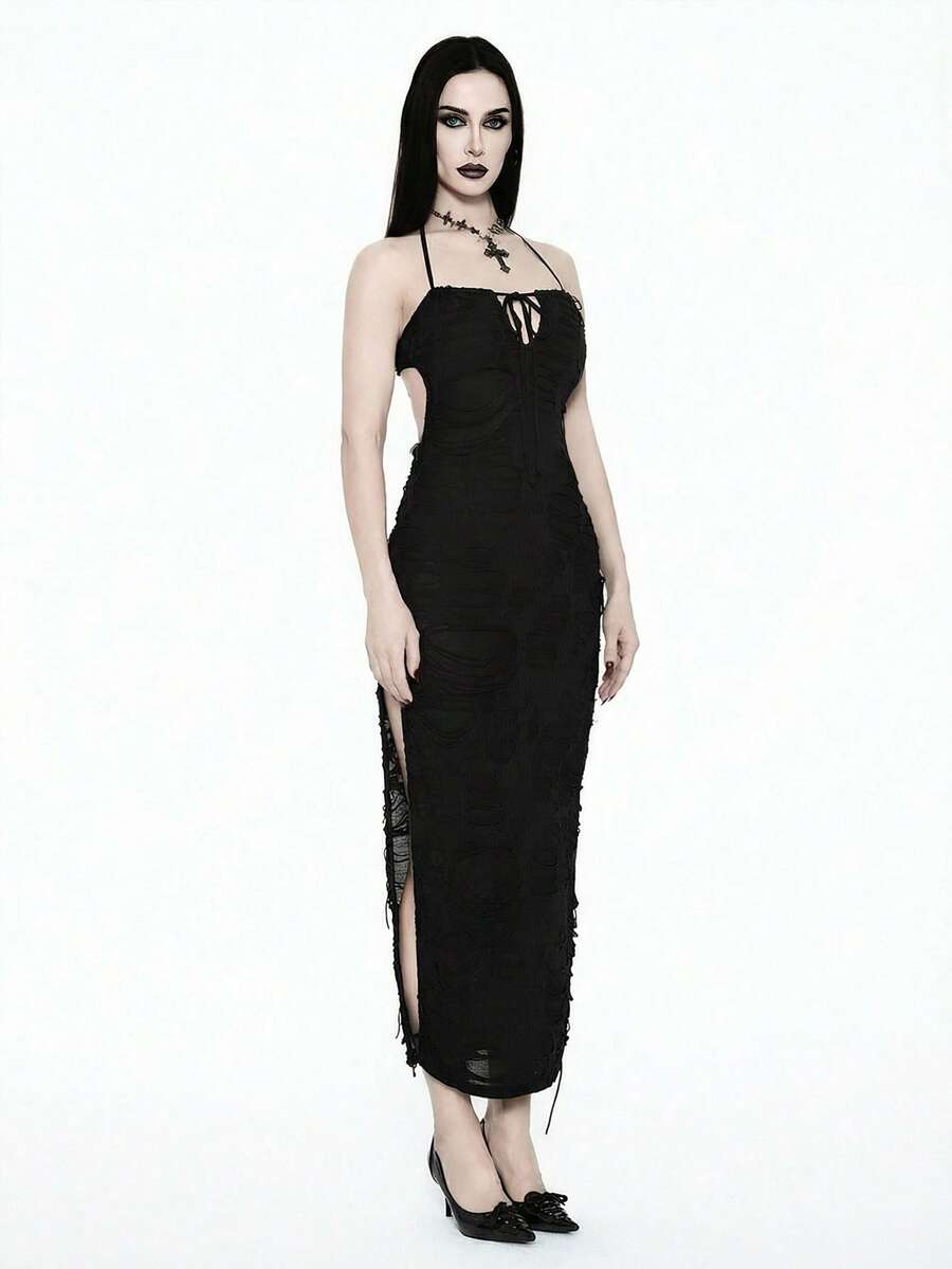 Woman wearing an elegant black sleeveless long cami dress featuring a slim fit silhouette and a backless tie-back design.