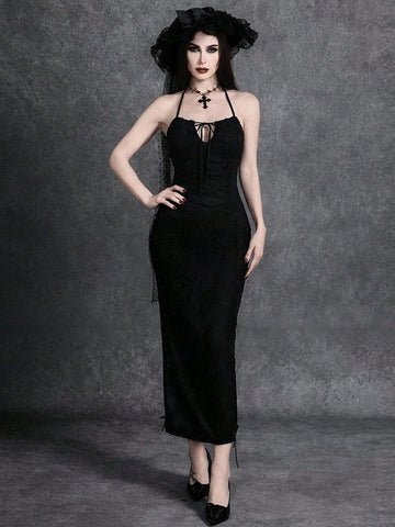 Woman wearing an elegant black sleeveless long cami dress featuring a slim fit silhouette and a backless tie-back design.