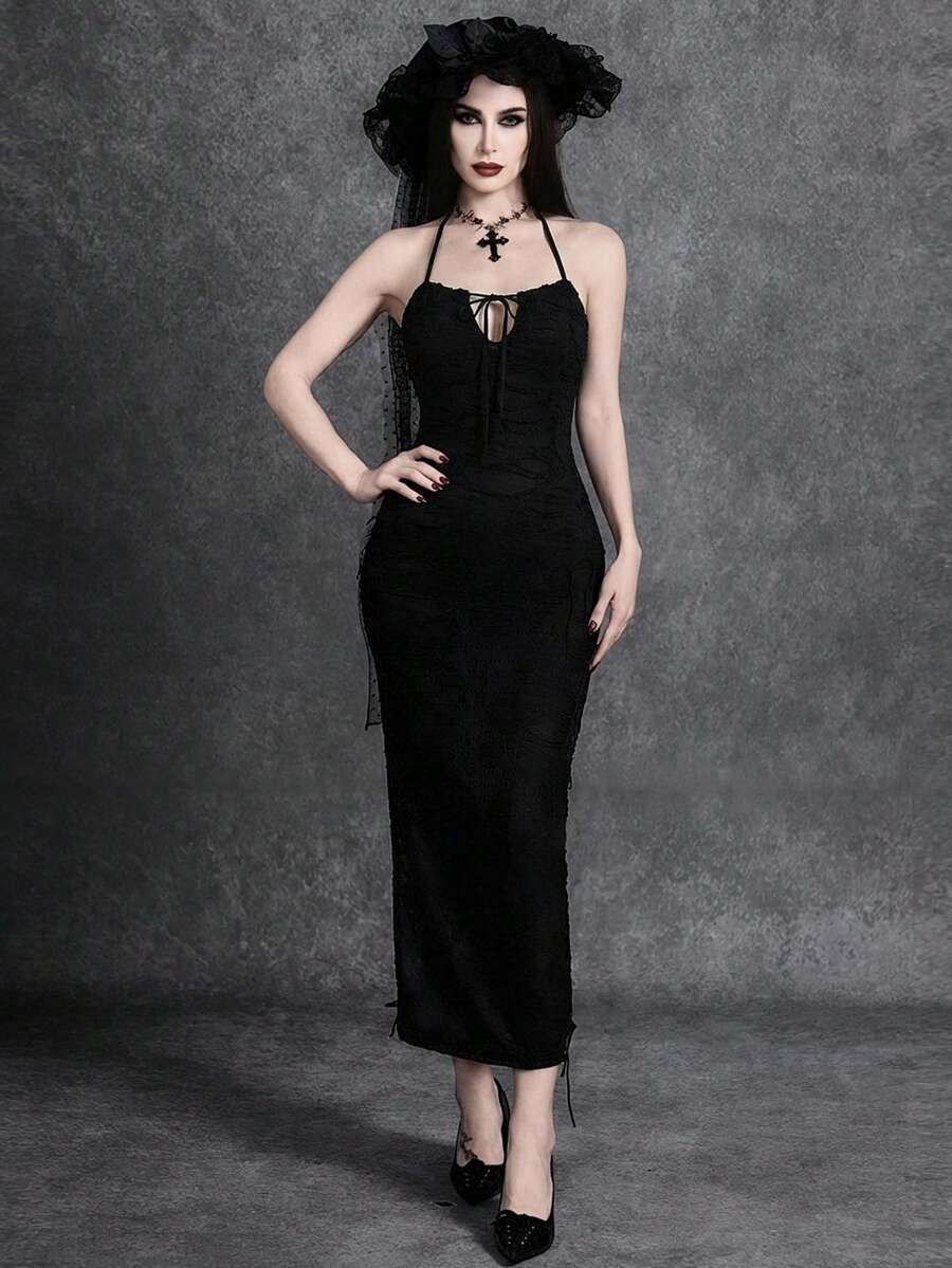 Woman wearing an elegant black sleeveless long cami dress featuring a slim fit silhouette and a backless tie-back design.