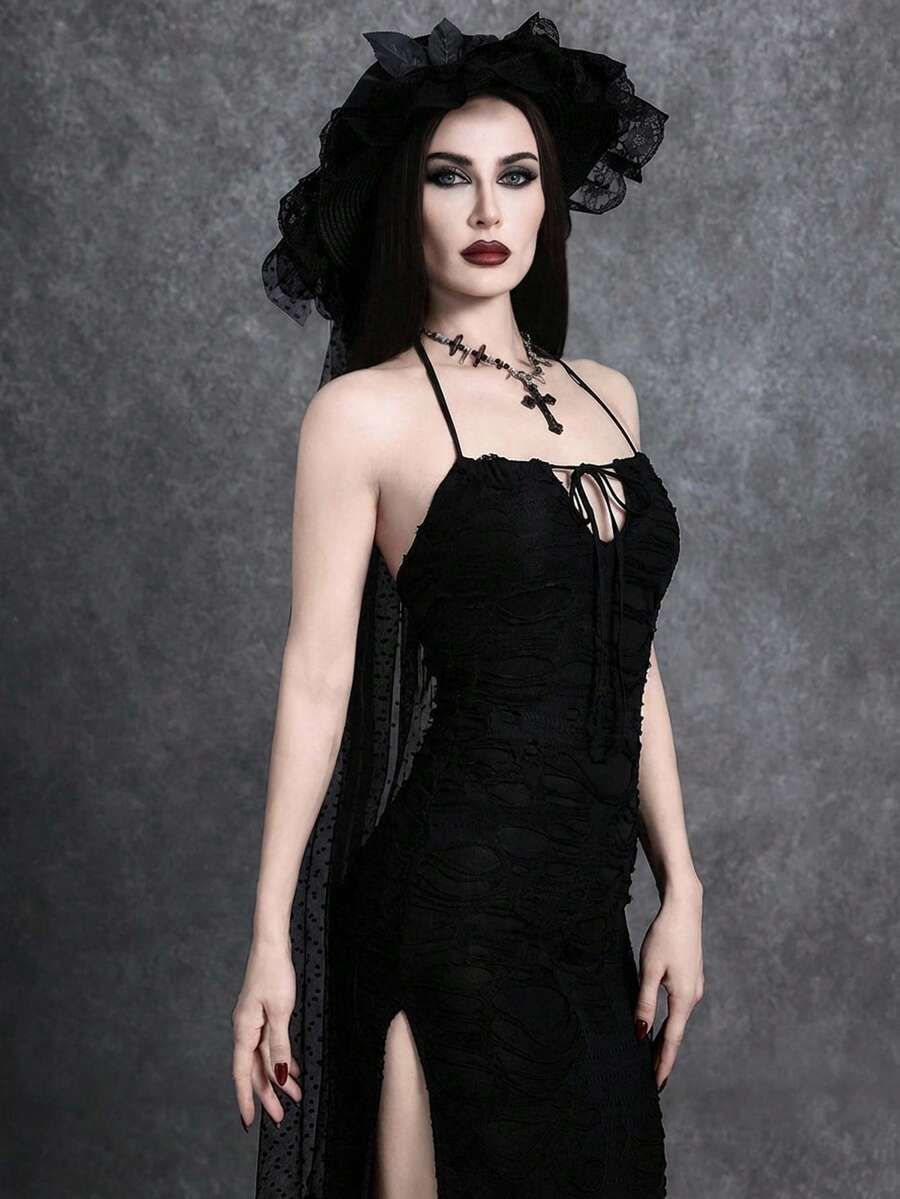 Woman wearing an elegant black sleeveless long cami dress featuring a slim fit silhouette and a backless tie-back design.