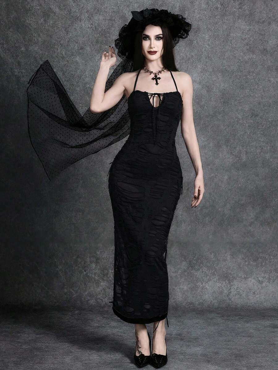 Woman wearing an elegant black sleeveless long cami dress featuring a slim fit silhouette and a backless tie-back design.