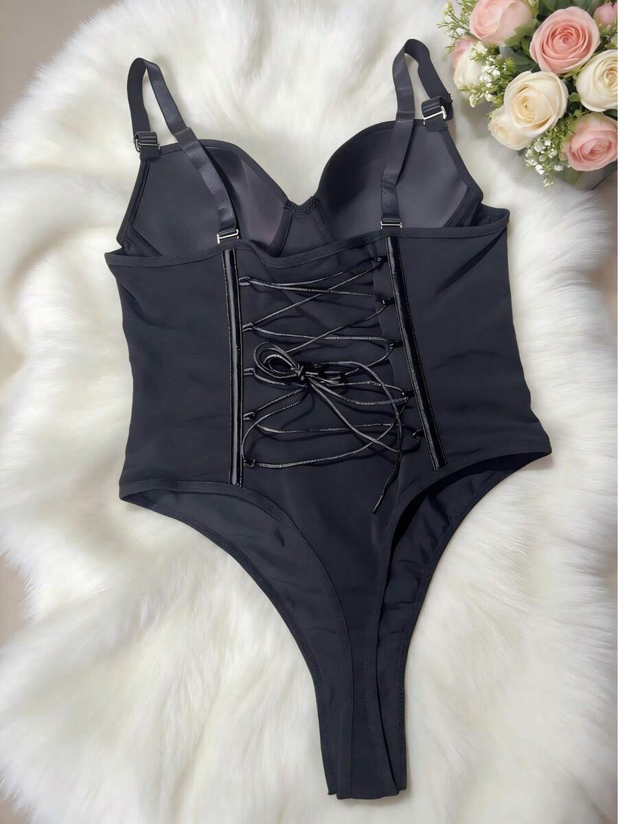 Black shapewear bodysuit for women featuring a built-in push-up bra, back tie, zipper closure, and Bermuda shorts length.