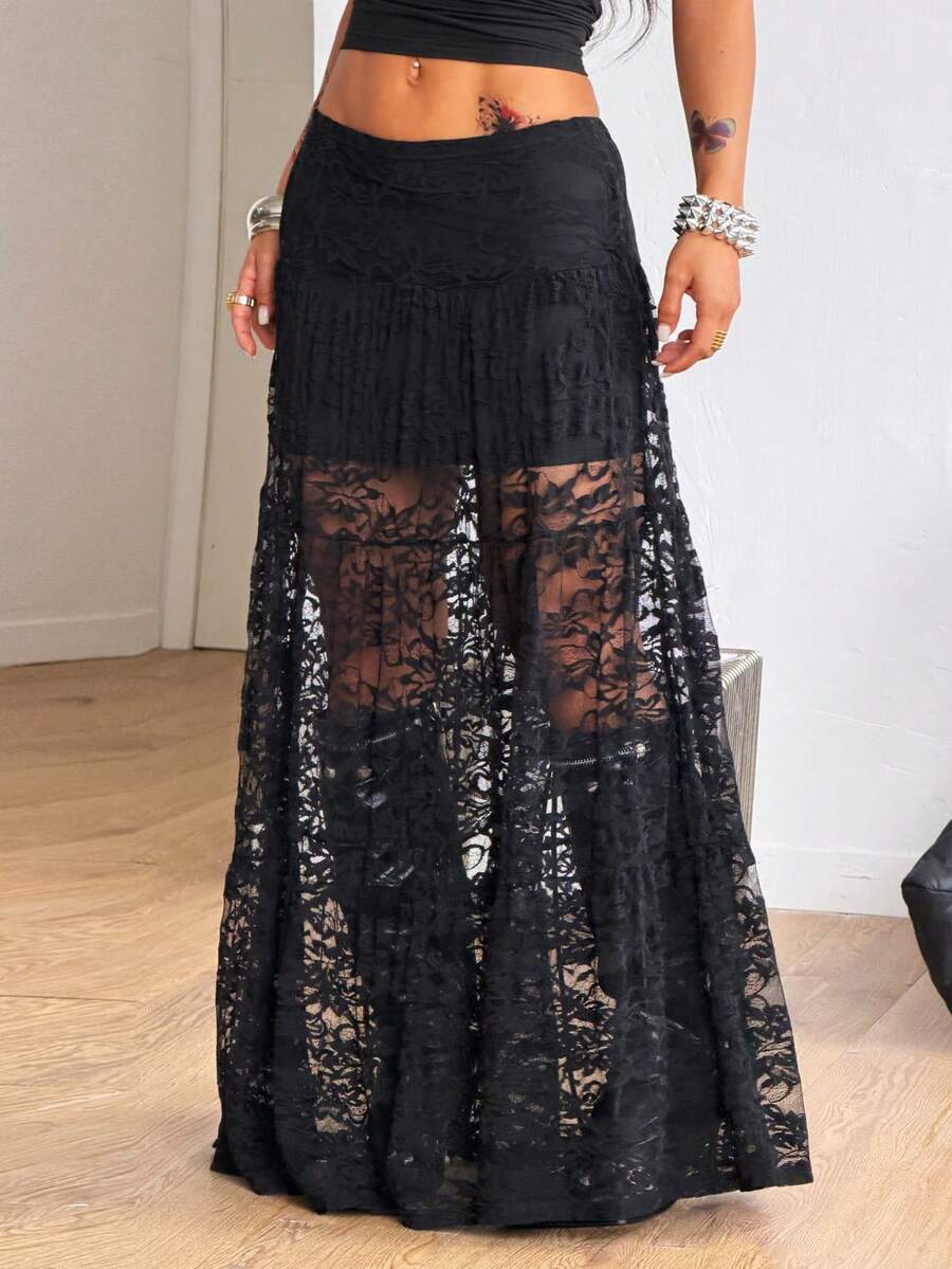 Women's black low waist split thigh long skirt featuring semi-sheer textured fabric and a flared skinny fit.