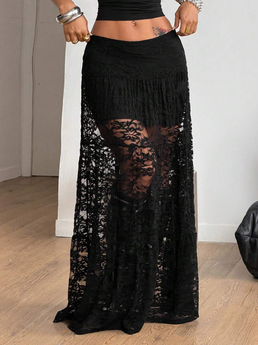 Women's black low waist split thigh long skirt featuring semi-sheer textured fabric and a flared skinny fit.