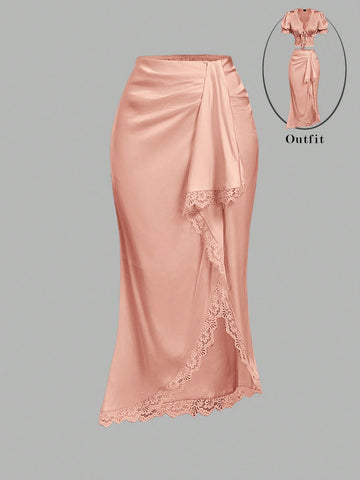 Women's elegant pink satin asymmetrical long skirt featuring contrast lace patchwork, ruched knot detailing, and a mid-waist mermaid cut.