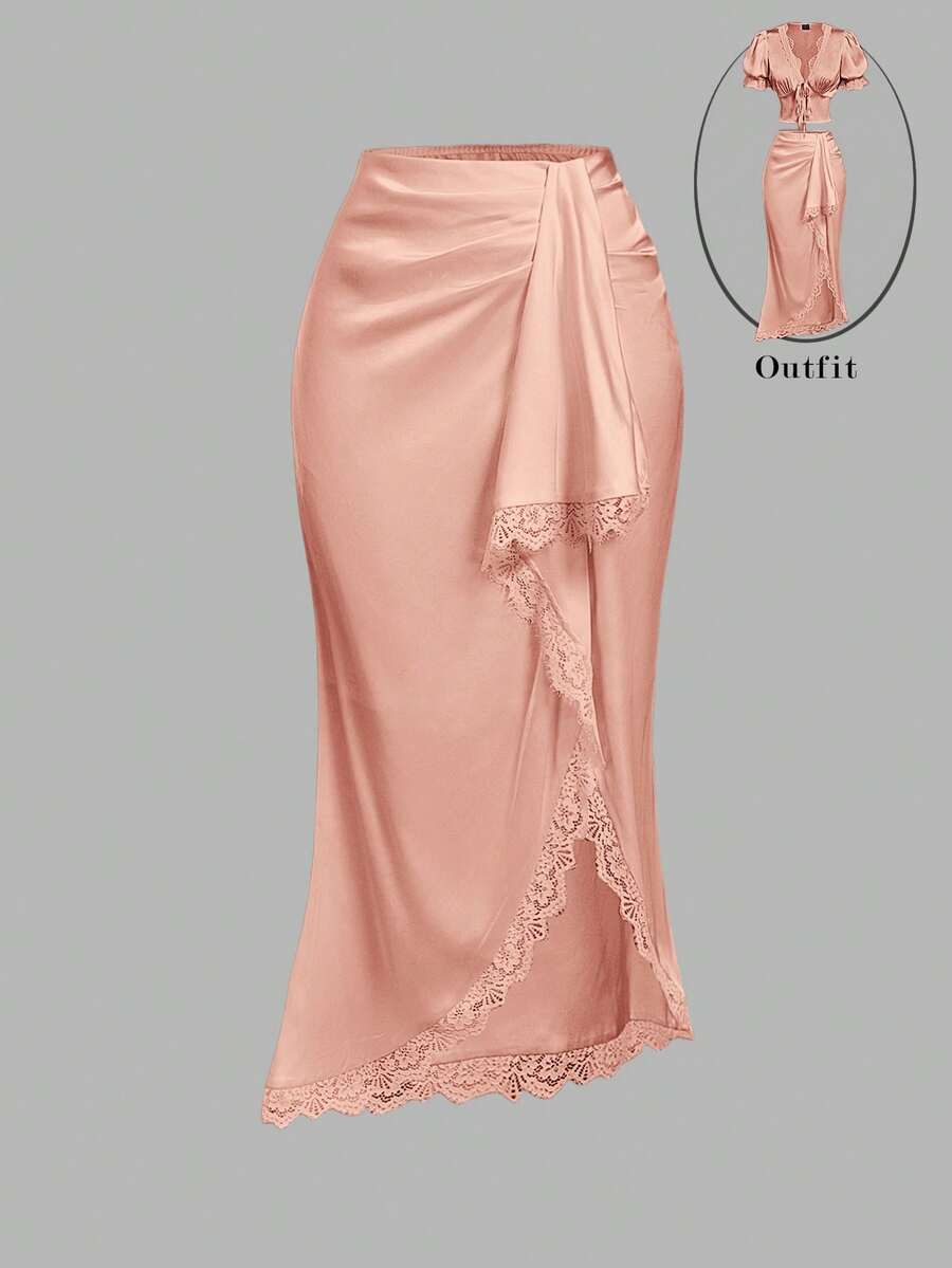 Women's elegant pink satin asymmetrical long skirt featuring contrast lace patchwork, ruched knot detailing, and a mid-waist mermaid cut.