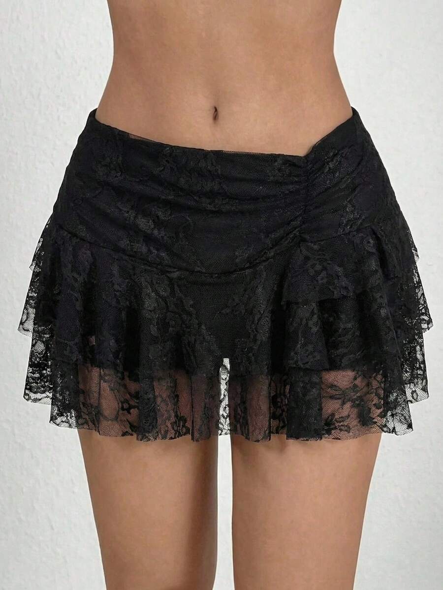 Black tiered ruffle mini cake skirt for women featuring a mid-waist pleated design and layered ruffle hem.