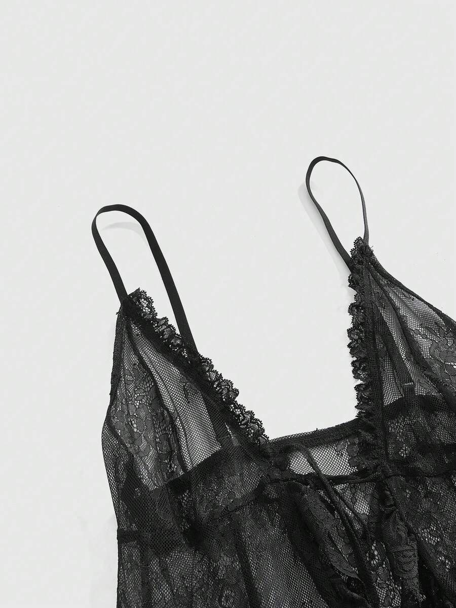 Woman wearing a black sheer lace maxi dress with spaghetti straps, high waist split thigh, and asymmetrical hem.