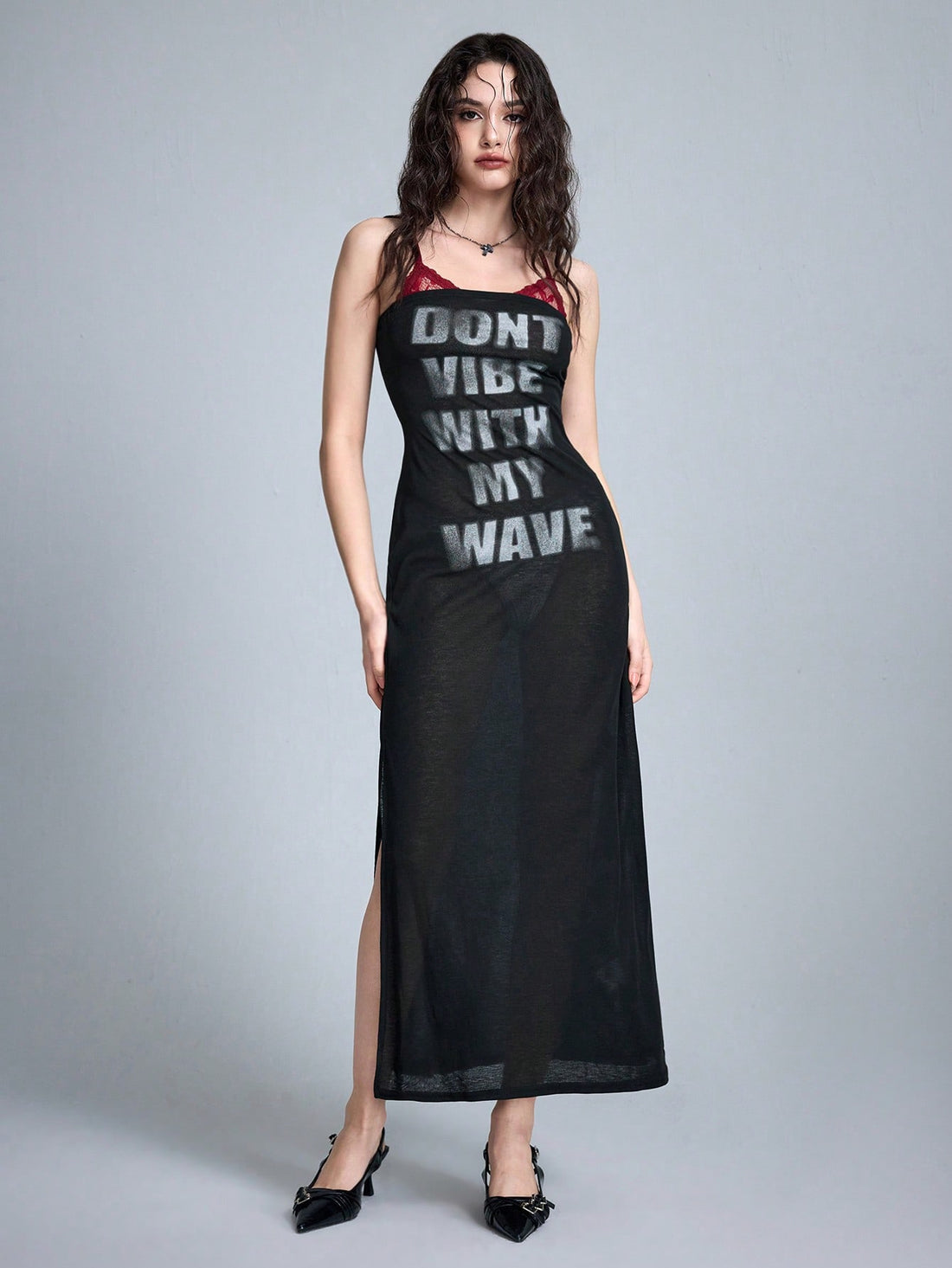 Women's black semi-sheer Y2K spaghetti strap maxi dress featuring contrast lace trim, asymmetrical split thigh hem, and matching arm sleeves.