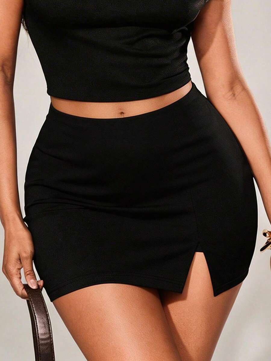 Women's black bodycon mini skort featuring a low waist, pleated side split hem, zipper closure, and built-in shorts.