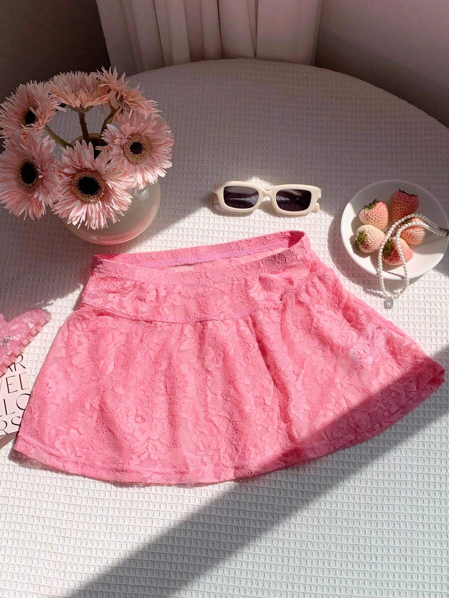 Women's black semi-sheer knitted lace mini skirt featuring a flared ruffle hem and low waist design