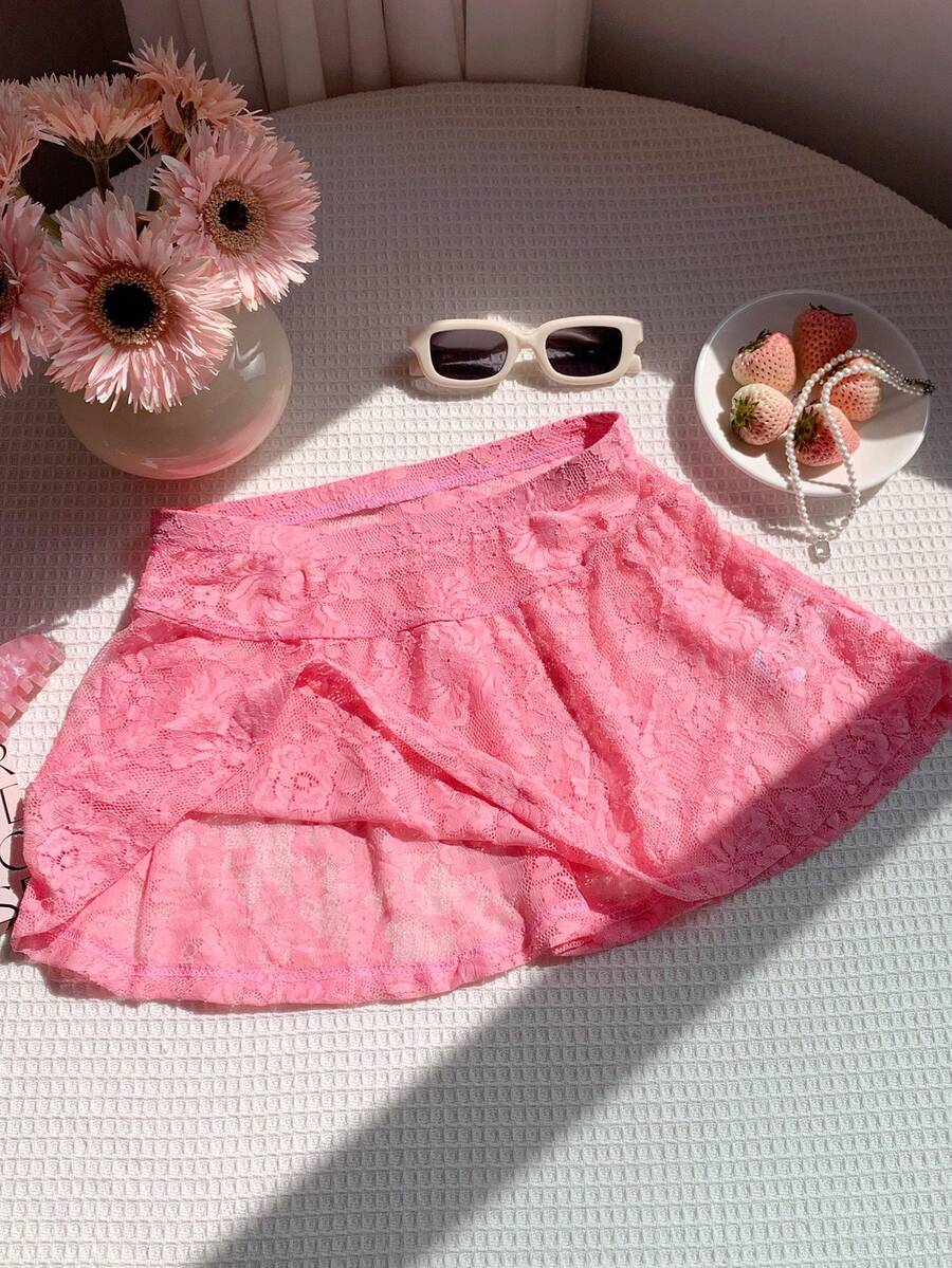 Women's black semi-sheer knitted lace mini skirt featuring a flared ruffle hem and low waist design