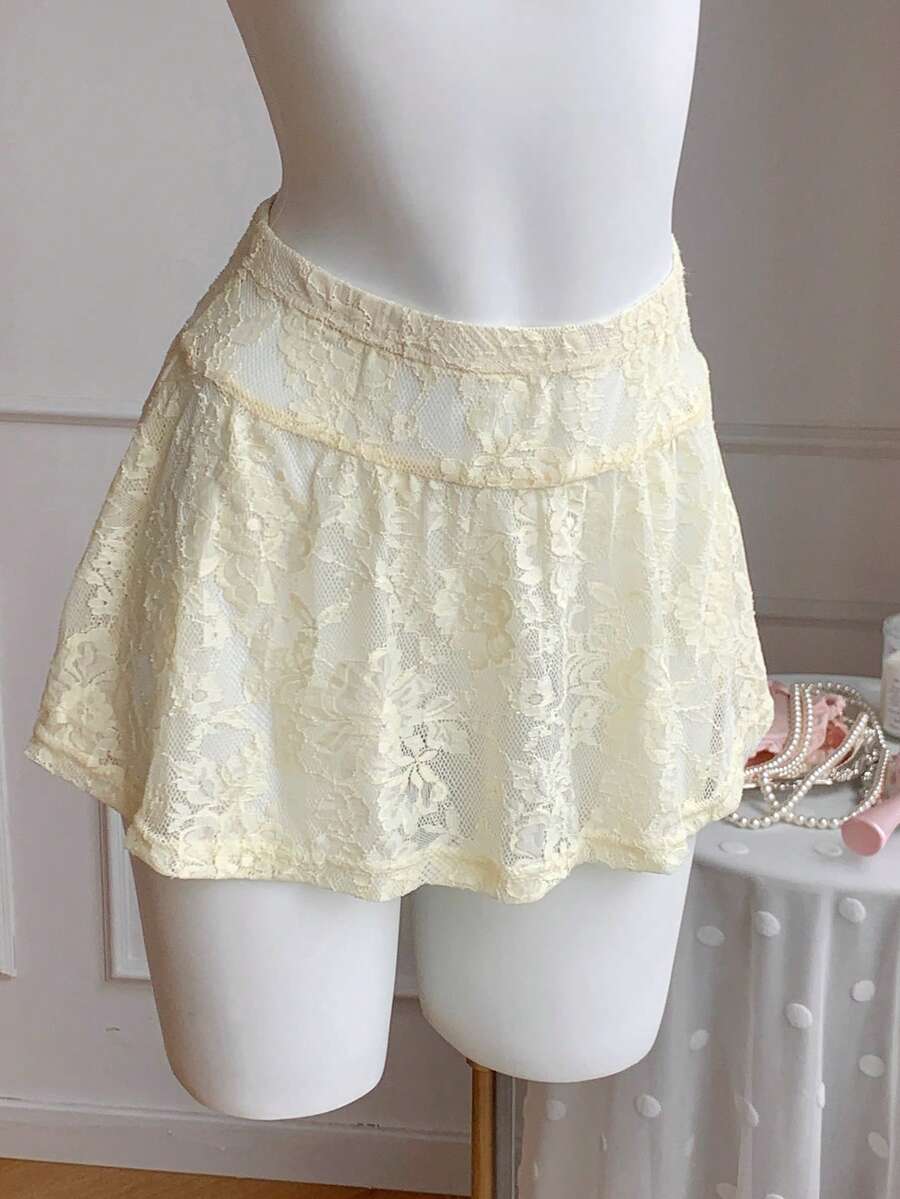 Women's black semi-sheer knitted lace mini skirt featuring a flared ruffle hem and low waist design