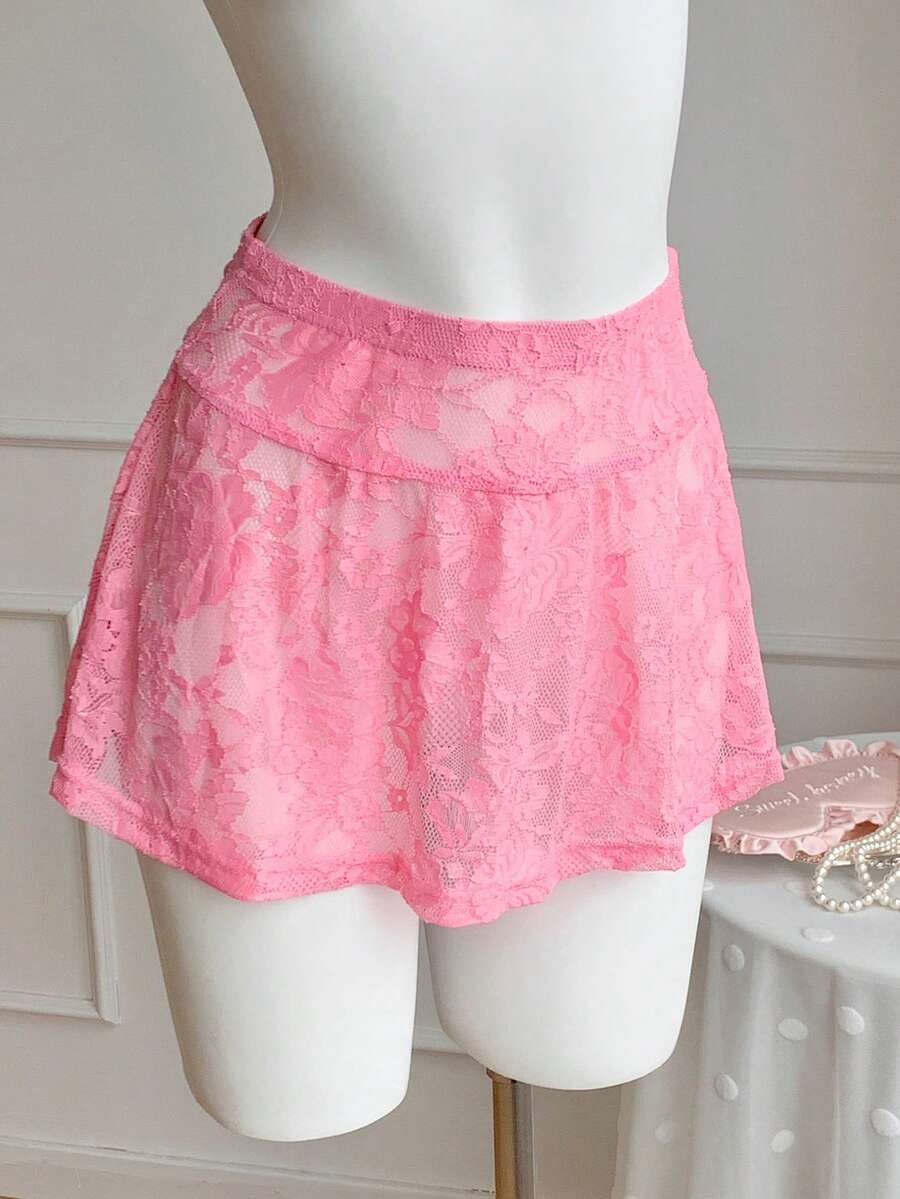 Women's black semi-sheer knitted lace mini skirt featuring a flared ruffle hem and low waist design