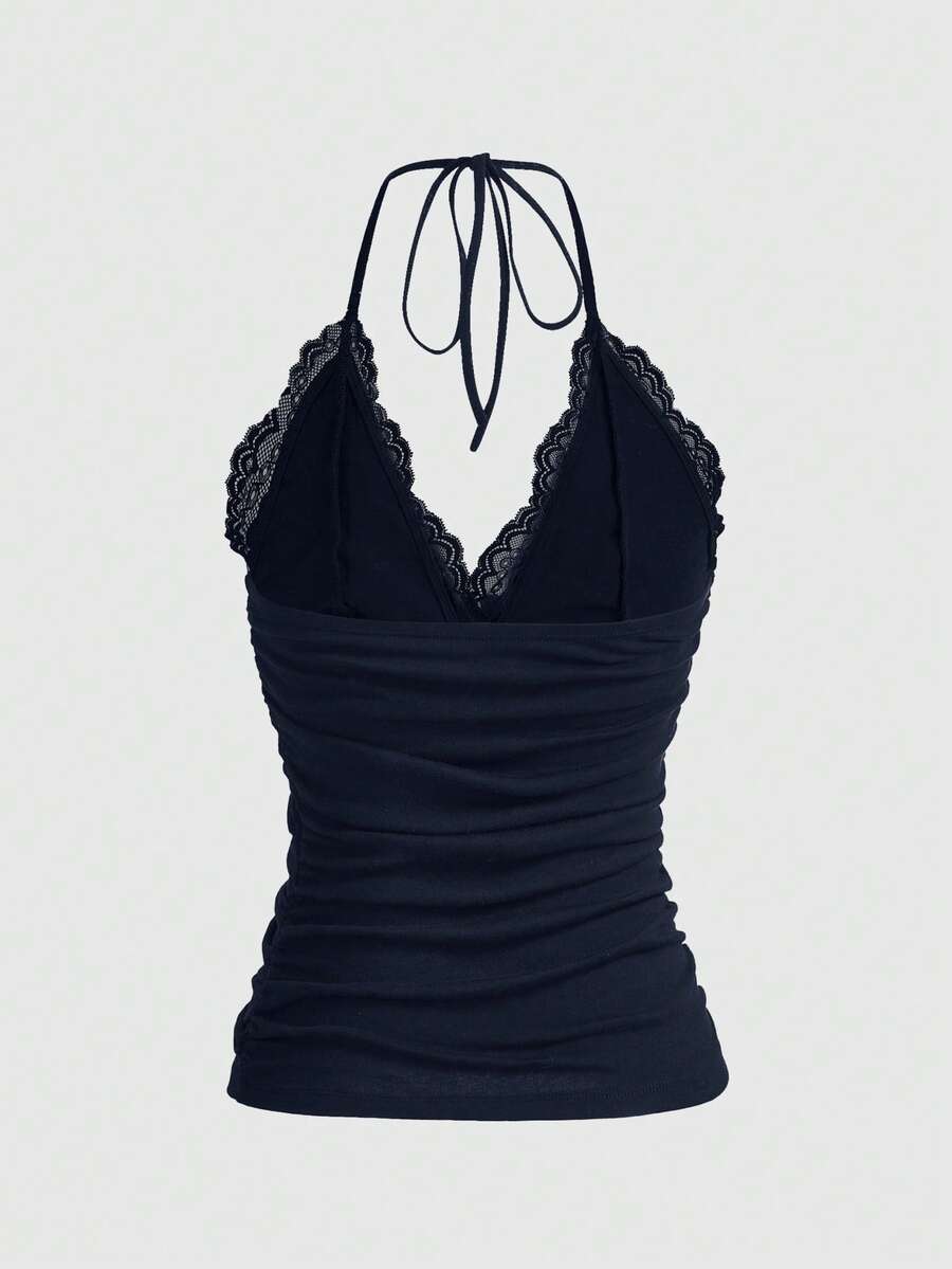 A women's black backless halter top featuring contrast lace trim, ruched front detail, and slim fit soft knitted fabric.