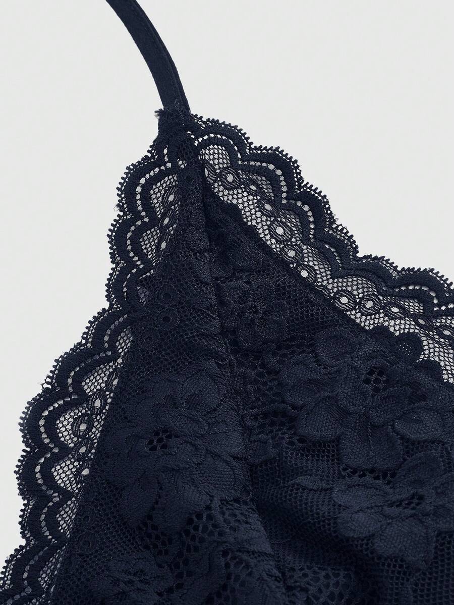 A women's black backless halter top featuring contrast lace trim, ruched front detail, and slim fit soft knitted fabric.