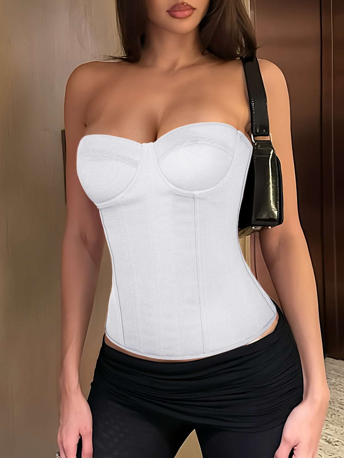 Black strapless corset top with boning, lace-up back, and a cropped slim-fit silhouette for women.