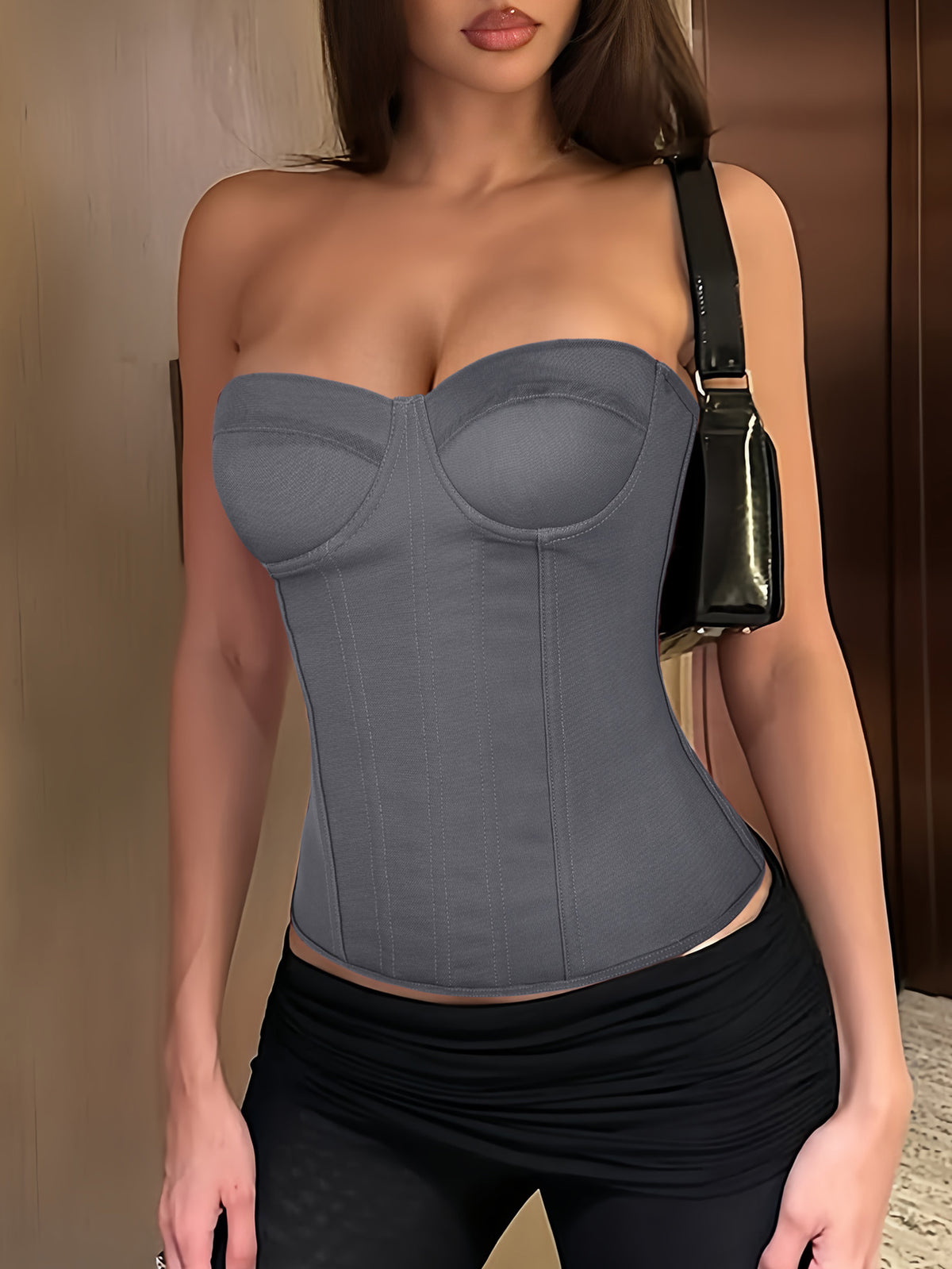Black strapless corset top with boning, lace-up back, and a cropped slim-fit silhouette for women.