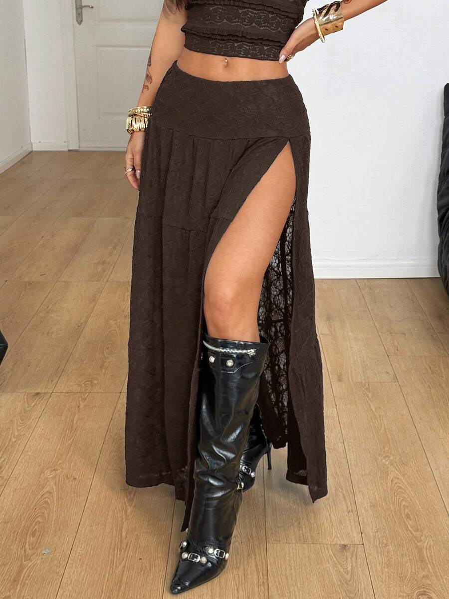 Women's black low waist split thigh long skirt featuring semi-sheer textured fabric and a flared skinny fit.