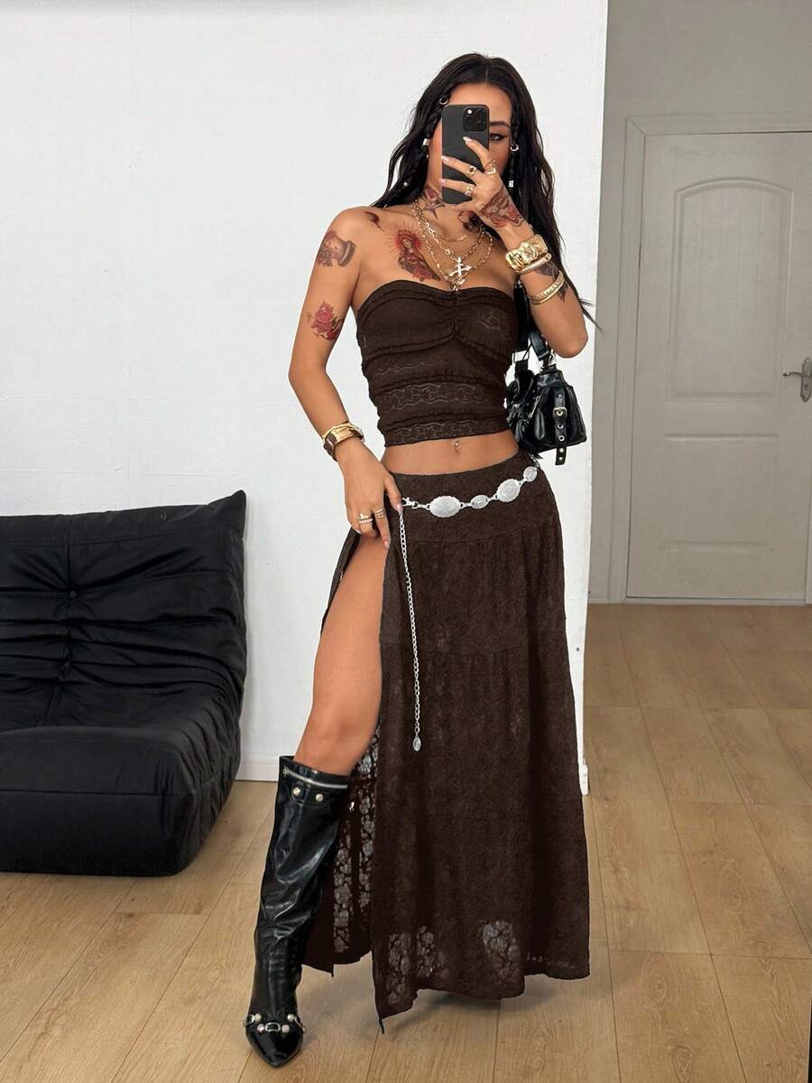 Women's black low waist split thigh long skirt featuring semi-sheer textured fabric and a flared skinny fit.